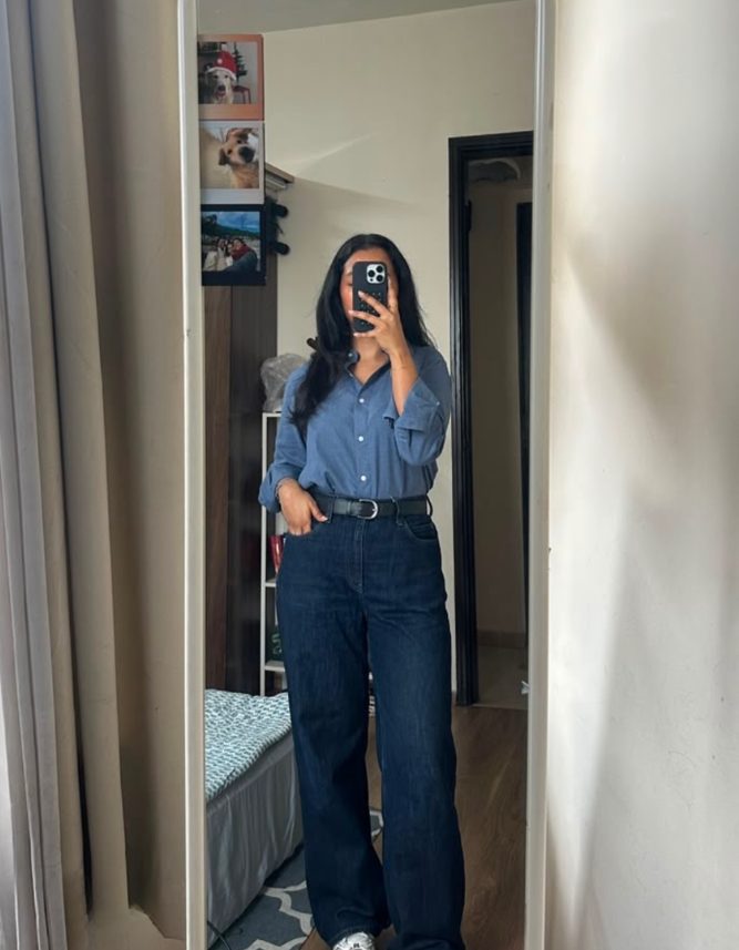 Sukanya wearing the Midnight Navy shirt with dark jeans